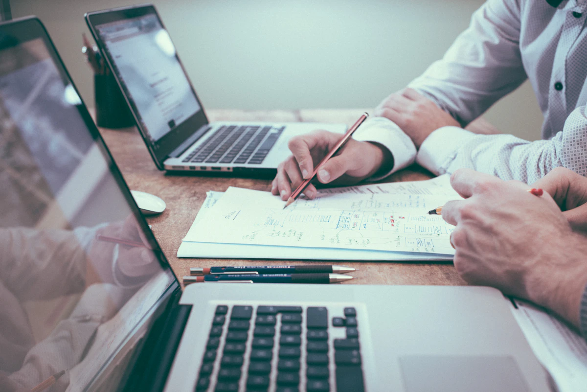 Person at a desk reviewing printed financial reports