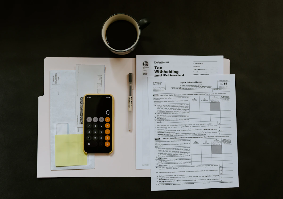 Printed bills and invoices arranged on a wooden desk