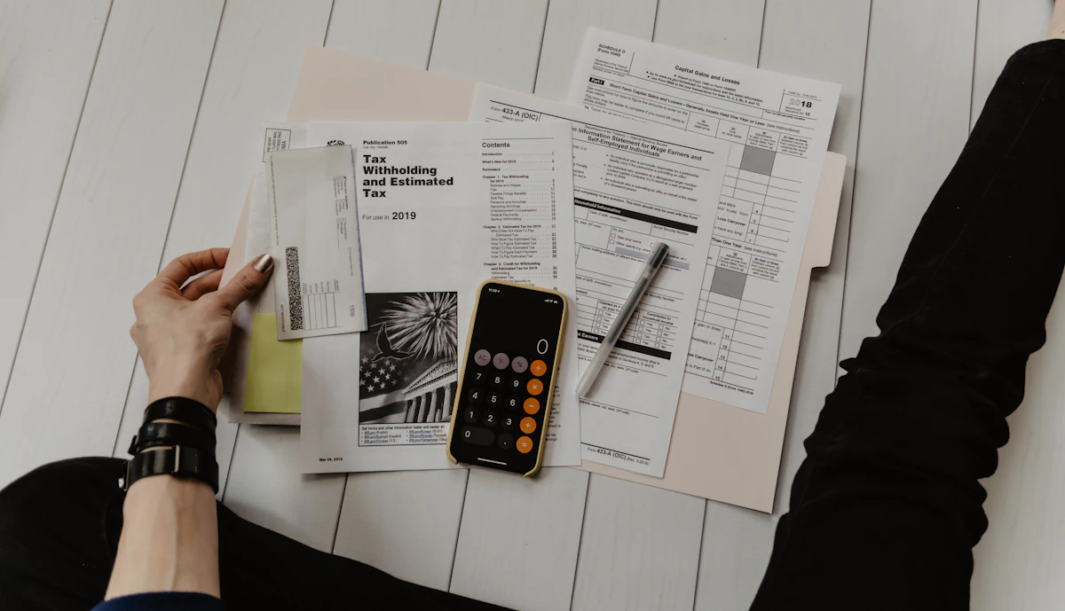 Map of the United States with tax related paperwork on a desk